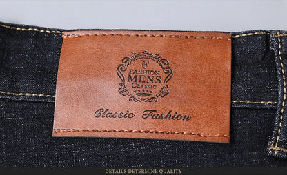 Branded leather patch on waistband of classic men’s jeans with decorative emblem