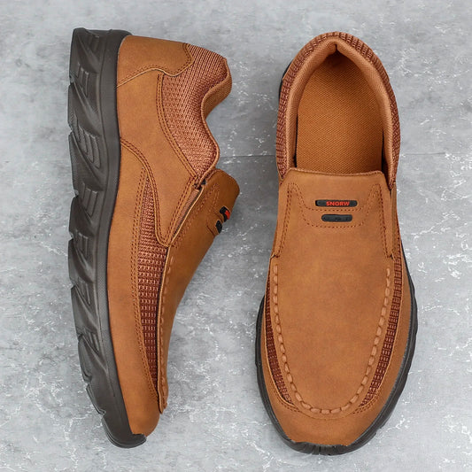 Brown leather casual shoes with mesh detail, flat lay view on grey background