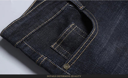 Close-up of front pocket detail with reinforced stitching on dark stretch jeans