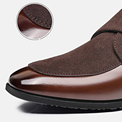 Close-up of metal buckle accent on brown men’s leather loafers