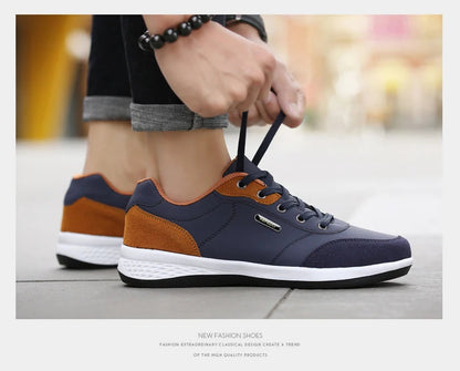 Close-up of navy and orange sneakers being tied on foot