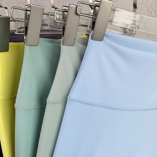Close-up of pastel yoga leggings hanging on a rack