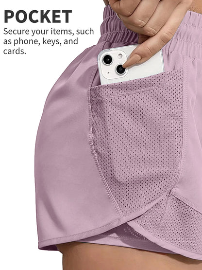 Close-up of phone in mesh pocket on pink workout shorts, secure storage feature