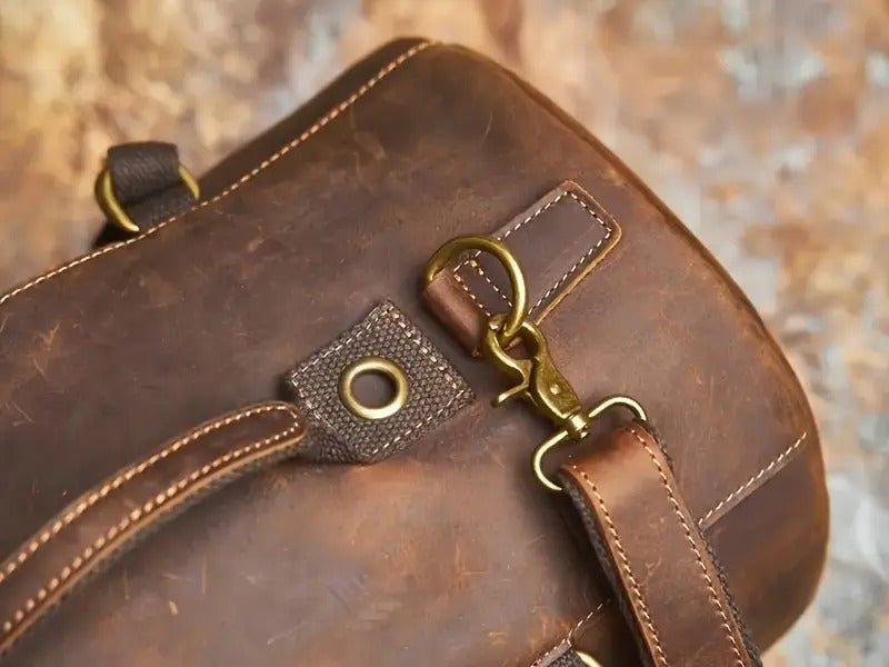 Close-up of strap attachment and rivet detailing on brown leather