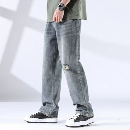 Close side-front view of storm grey blue distressed jeans with fading detail