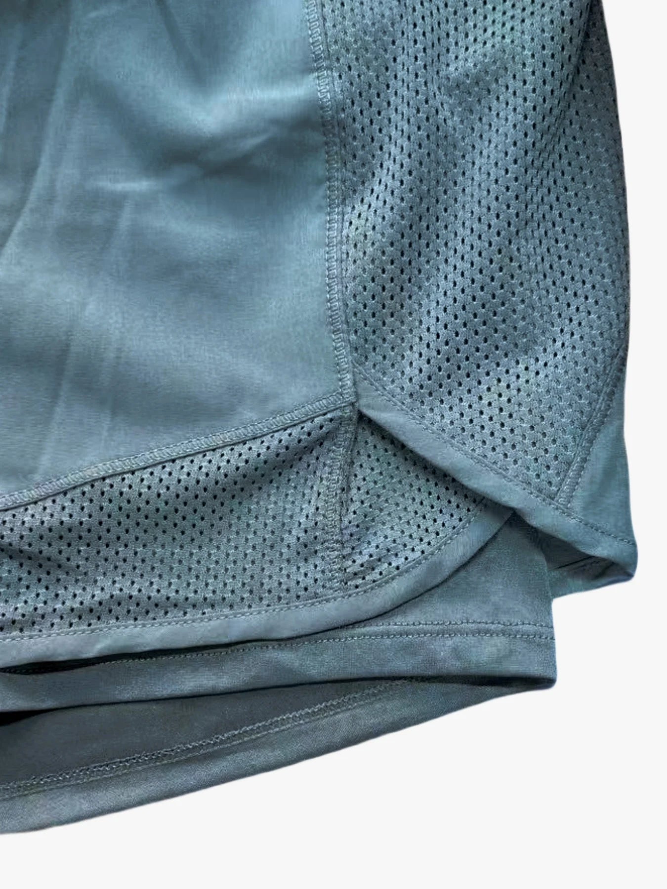 Detailed close-up of teal workout shorts waistband and braided drawstring tie