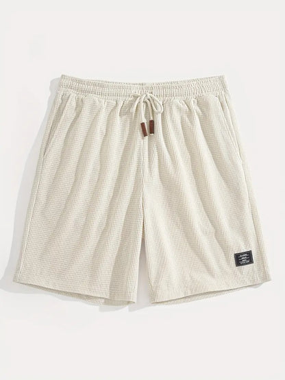 Flat lay of cream textured drawstring casual shorts, front and back view side by side