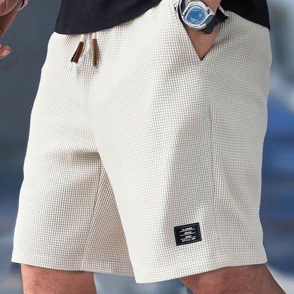 Flat lay of cream textured drawstring casual shorts, front view