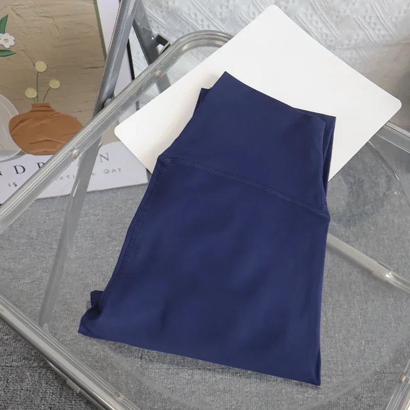 Folded dark blue yoga leggings on chair