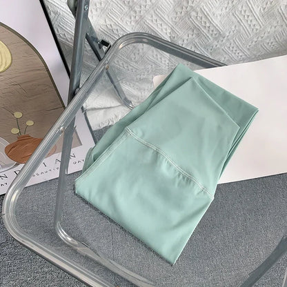 Folded mint green yoga leggings on chair