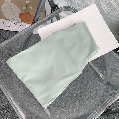 Folded mint green yoga leggings on the chair