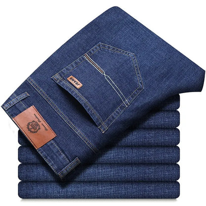 Folded stack of classic men’s straight-leg jeans in medium blue denim, back pocket view