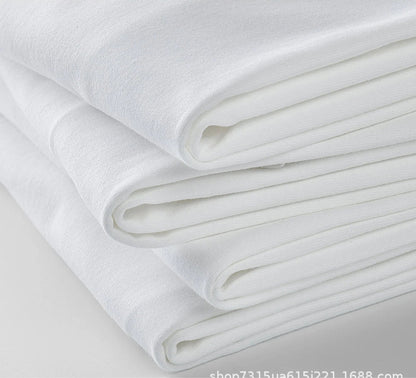 Folded stack of heavyweight combed cotton fabric in white