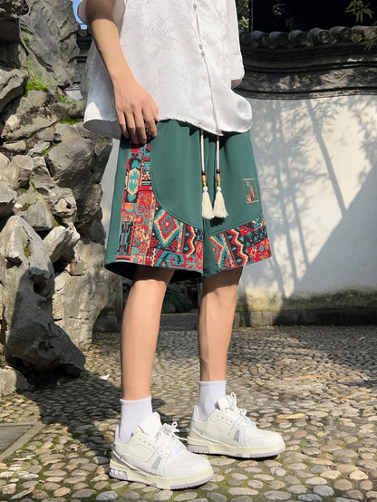 Full-body view of green patchwork shorts paired with white shirt and sneakers