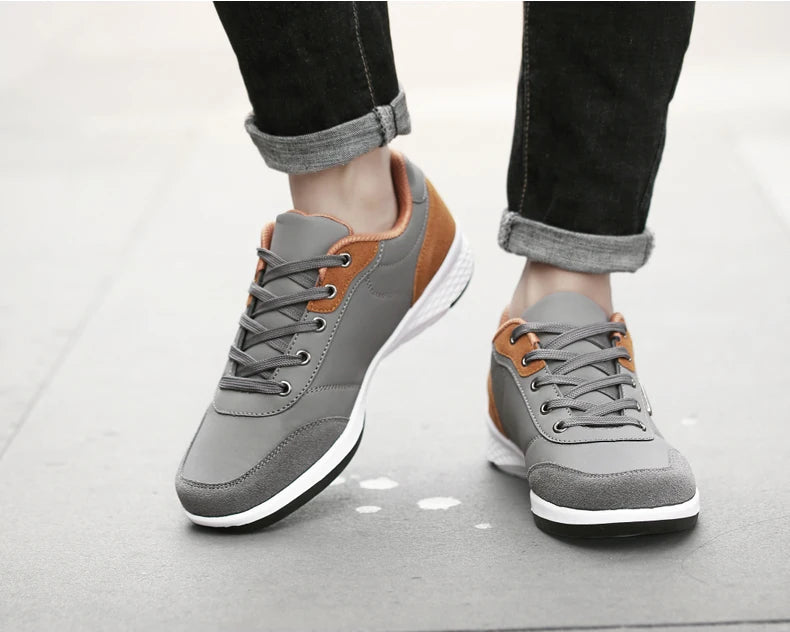 Grey and orange sneakers on person walking casually