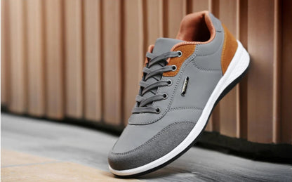 Grey and orange walking sneaker shown raised with heel detail