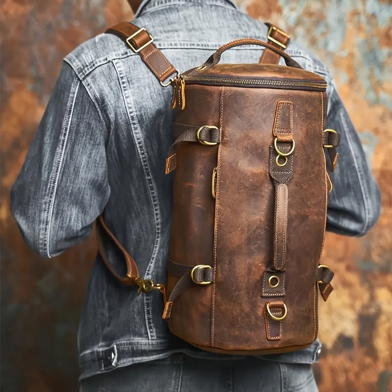 Leather backpack worn on back, showcasing vertical shape and brass hardware