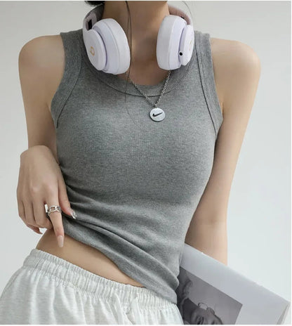 Light gray ribbed tank top with integrated bra padding, worn with white shorts