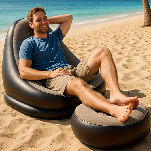 Man relaxing on inflatable sofa chair with footrest on the beach
