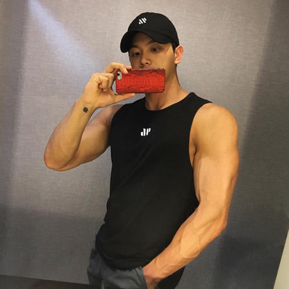 Man wearing black mesh training tank top with reflective logo, mirror selfie view