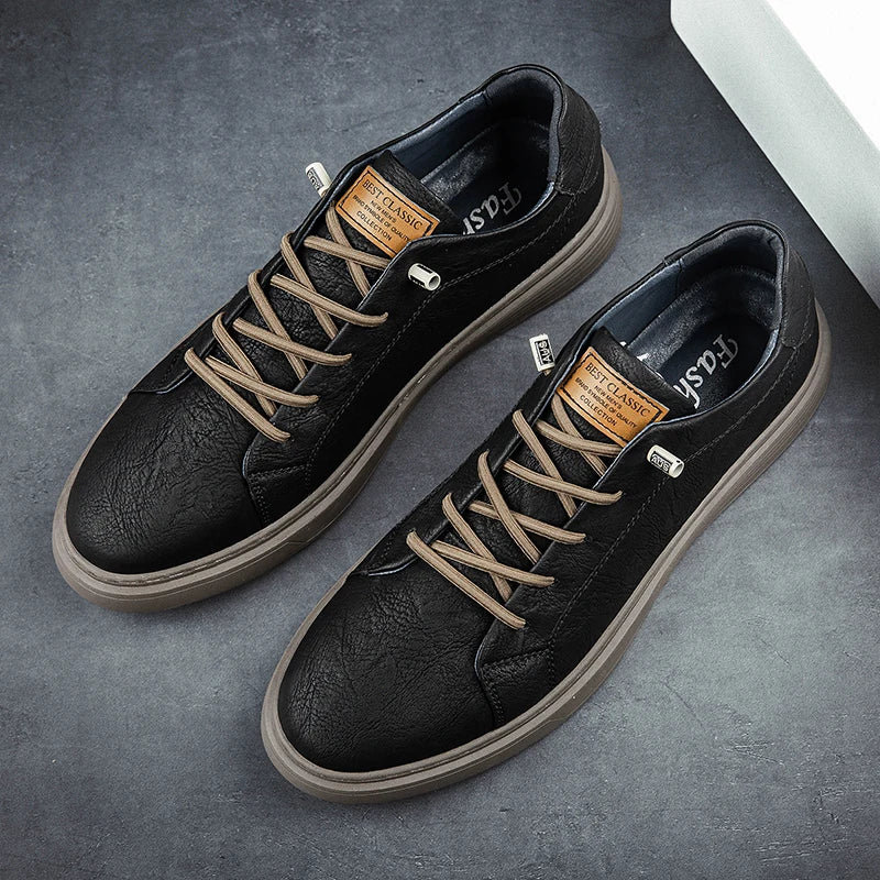 Pair of black leather sneakers from top view showing lacing and sole detail