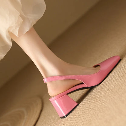Pink patent leather slingback heels showing heel and strap design, side view
