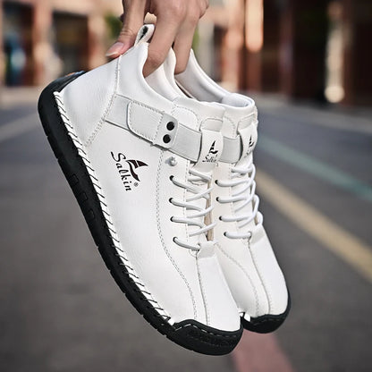 Side view of breathable brown handmade sneakers with stitched edge and pull tab