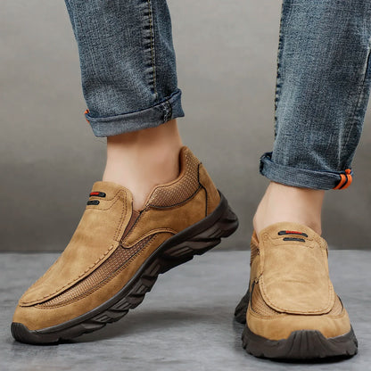 Tan suede leather casual shoes styled with cuffed jeans, front walking angle