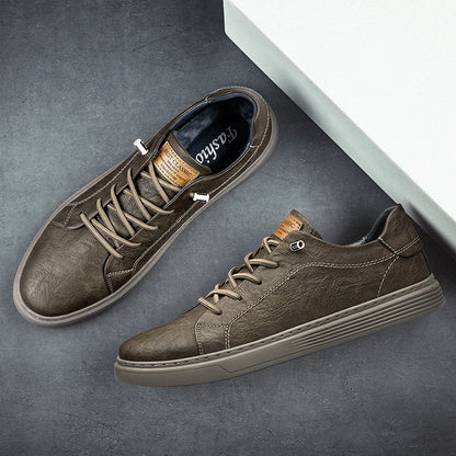 Top and side view of taupe brown leather sneakers with textured finish on grey background