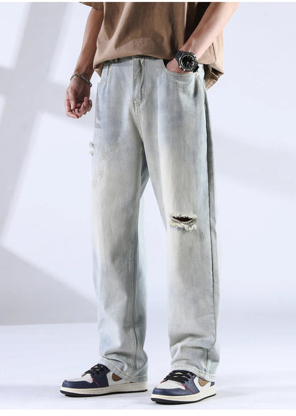 Washed black ripped denim jeans with light fade and casual styling shown from front
