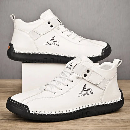 White handmade ankle sneakers with breathable fit and stitched sole, studio shot