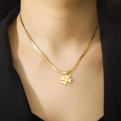 old clover pendant necklace worn with black blouse, natural light